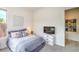 This bedroom is adjacent to ensuite bathroom and features a decorative dresser with flatscreen television at 6728 Regency Ridge Ct, Las Vegas, NV 89148