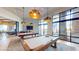 Community billiards room with pool tables, comfortable seating, large windows, and stylish light fixtures at 6728 Regency Ridge Ct, Las Vegas, NV 89148