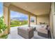 Inviting covered patio with comfortable seating and views of the green lawn and landscaped yard at 6728 Regency Ridge Ct, Las Vegas, NV 89148