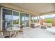 Spacious covered patio with wicker furniture, a dining table, and views of the landscaped backyard at 6728 Regency Ridge Ct, Las Vegas, NV 89148