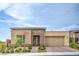 Stylish single-story home with stone accents, desert landscaping, and a two-car garage on a sunny day at 6728 Regency Ridge Ct, Las Vegas, NV 89148