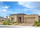 A charming single-story home featuring desert landscaping, neutral tones, and a brick driveway at 6728 Regency Ridge Ct, Las Vegas, NV 89148