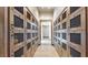 Hallway lined with wooden lockers featuring mesh fronts and elegant hardware, illuminated by recessed lighting at 6728 Regency Ridge Ct, Las Vegas, NV 89148