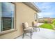 Relaxing outdoor seating area on a patio, with plush cushions and view of artificial grass at 6728 Regency Ridge Ct, Las Vegas, NV 89148