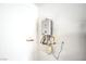 Modern tankless water heater on a clean, white wall, showing updated utility features at 6728 Regency Ridge Ct, Las Vegas, NV 89148