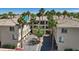Exterior of a multi-story condo building with palm trees in a well maintained community at 7119 S Durango Dr # 211, Las Vegas, NV 89113