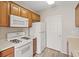 Kitchen with white appliances, gas range and light wood cabinets at 7119 S Durango Dr # 211, Las Vegas, NV 89113