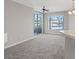 Bright living room featuring carpeting, fan, and access to an outdoor balcony at 7119 S Durango Dr # 211, Las Vegas, NV 89113