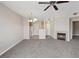 Spacious living room featuring plush carpeting and a cozy fireplace, open to the kitchen at 7119 S Durango Dr # 211, Las Vegas, NV 89113
