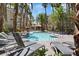 Resort-style pool surrounded by lounge chairs and palm trees, perfect for relaxation at 7119 S Durango Dr # 211, Las Vegas, NV 89113