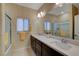 Elegant bathroom featuring a double vanity, large mirror, and a separate shower area with great natural light at 7208 Grace Estate Ave, Las Vegas, NV 89113