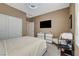 Bright bedroom featuring a clean aesthetic with a comfortable bed, tv and ample natural light at 7208 Grace Estate Ave, Las Vegas, NV 89113