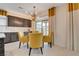 Cozy dining area with dark cabinets, pendant lighting, and access to the outdoor space at 7208 Grace Estate Ave, Las Vegas, NV 89113