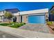 Single-story home with stone accents, desert landscaping and a blue garage door at 7208 Grace Estate Ave, Las Vegas, NV 89113