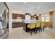 Modern kitchen features stainless steel appliances, dark cabinetry, and a large center island with bar seating at 7208 Grace Estate Ave, Las Vegas, NV 89113