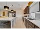 Bright kitchen featuring stainless steel appliances, dark cabinets, ample counter space and modern pendant lighting at 7208 Grace Estate Ave, Las Vegas, NV 89113