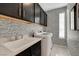Functional laundry room with modern appliances, stylish wallpaper, and ample storage space, designed for convenience at 7208 Grace Estate Ave, Las Vegas, NV 89113