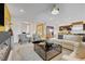 Spacious living room with contemporary decor, an electric fireplace, and seamless access to the kitchen at 7208 Grace Estate Ave, Las Vegas, NV 89113