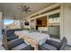 Covered outdoor patio featuring a dining table, comfortable seating, and seamless indoor-outdoor flow at 7208 Grace Estate Ave, Las Vegas, NV 89113