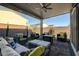 Covered patio with comfortable seating area, including sofa, chairs, ottoman and coffee table at 7208 Grace Estate Ave, Las Vegas, NV 89113