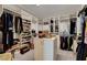 Spacious walk-in closet with ample shelving, hanging space and a central island for accessories and bags at 7208 Grace Estate Ave, Las Vegas, NV 89113