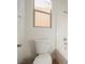 Bathroom featuring a toilet, window, and tub with shower at 7466 Matilda St, Las Vegas, NV 89113