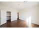 Bedroom with hardwood floors, white walls, and walk-in closet at 7466 Matilda St, Las Vegas, NV 89113