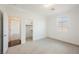 Bright bedroom with neutral carpet, white walls, and a walk-in closet at 7466 Matilda St, Las Vegas, NV 89113