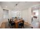 Dining room with modern chandelier, wood table, neutral paint, and window at 7466 Matilda St, Las Vegas, NV 89113