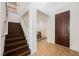 Inviting entryway featuring hardwood stairs, white railing, and a view of the dining area at 7466 Matilda St, Las Vegas, NV 89113