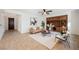 Open living room with built-in shelves, ceiling fan, neutral paint, and tile flooring at 7466 Matilda St, Las Vegas, NV 89113