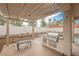 Outdoor kitchen on patio with built-in grill, shaded by pergola and seating area at 7466 Matilda St, Las Vegas, NV 89113