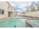 Backyard swimming pool and spa with outdoor kitchen and covered patio at 7466 Matilda St, Las Vegas, NV 89113