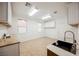 Bright utility room featuring ample counter space, cabinetry, sink and large windows at 7466 Matilda St, Las Vegas, NV 89113