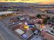Real estate photo features a home with ample parking, outbuildings, and a peek at the city beyond at 7477 Ullom Dr, Las Vegas, NV 89139
