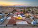 This captivating aerial image highlights a large lot, privacy fence, and beautiful city views at 7477 Ullom Dr, Las Vegas, NV 89139