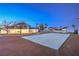 Large backyard with a concrete pad perfect for recreation and entertaining at twilight at 7477 Ullom Dr, Las Vegas, NV 89139