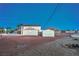 Backyard featuring a detached garage or shed and chainlink fencing at dusk at 7477 Ullom Dr, Las Vegas, NV 89139