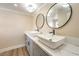 Bathroom featuring dual sinks, modern faucets, and quartz countertops with sleek, contemporary design at 7477 Ullom Dr, Las Vegas, NV 89139