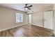 A neutral bedroom features a ceiling fan, window with blinds, and wood-look flooring at 7477 Ullom Dr, Las Vegas, NV 89139