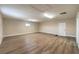 A large bonus room features neutral paint, wood-look floors, and access to the exterior at 7477 Ullom Dr, Las Vegas, NV 89139