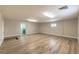 A large bonus room has neutral paint, wood-look floors, and is adjacent to the laundry room at 7477 Ullom Dr, Las Vegas, NV 89139
