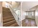 Bright entryway featuring new wood flooring, a staircase with white banister, and natural light at 7477 Ullom Dr, Las Vegas, NV 89139