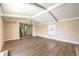 Spacious living room featuring a chandelier, new wood floors, and access to the staircase at 7477 Ullom Dr, Las Vegas, NV 89139