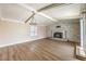 Spacious living room with fireplace, new wood floors, bright light, and vaulted ceilings at 7477 Ullom Dr, Las Vegas, NV 89139