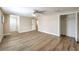 This primary bedroom features an open closet space and neutral walls and wood-look flooring at 7477 Ullom Dr, Las Vegas, NV 89139