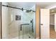 Marble tiled walk-in shower with sliding glass door and sleek matte black hardware at 7477 Ullom Dr, Las Vegas, NV 89139