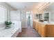 Elegant bathroom with soaking tub, shower, and double vanity offers relaxation at 7857 Midnight Ride St, Las Vegas, NV 89131