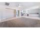 Open-concept living room flows into the kitchen, featuring stainless steel appliances and ample cabinet space at 7857 Midnight Ride St, Las Vegas, NV 89131