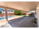 Covered patio showcases a view of the pool and landscaped backyard, offering a relaxing outdoor space at 7857 Midnight Ride St, Las Vegas, NV 89131